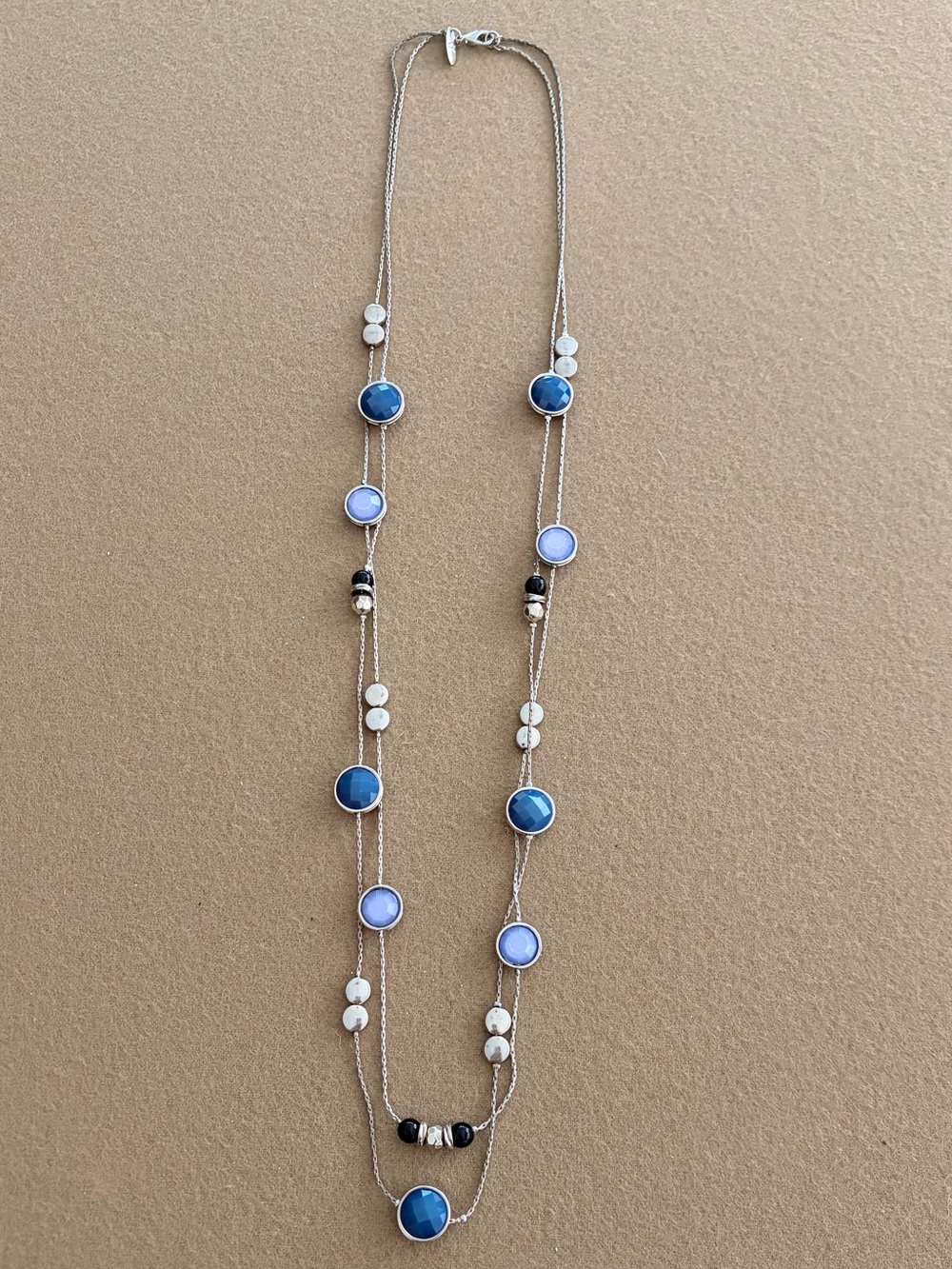 Long silver necklace with blue circles